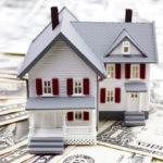 home equity concept - house on top of pile of money